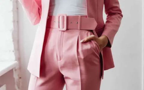 Dettaglio di un completo rosa cipria con giacca elegante e pantaloni a vita alta. La cura per lavare giacca elegante in lavatrice è fondamentale per mantenerla impeccabile.